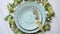Easter table setting with flowers and eggs. Empty decorative ceramic plates