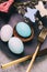 Easter table setting with grey plate and blue egg in nest on grey wooden table, close-up