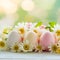 Easter themed arrangement pastel eggs, flowers against soft focus backdrop