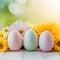 Easter themed arrangement pastel eggs, flowers against soft focus backdrop