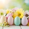 Easter themed arrangement pastel eggs, flowers against soft focus backdrop