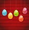 Easter three ornamental colorful eggs on wooden background