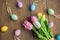 Easter traditional objects on dark wooden background colorful eggs and tulips