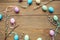 Easter traditional objects on dark wooden background colorful eggs and willow