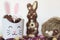 Easter treat box with candies, chocolate rabbit and nest with easter almond