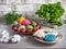 Easter treat of colored eggs, painted gingerbread, fresh herbs, willow twigs and decorative cotton for decoration