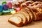 Easter tsoureki braid slices, greek easter sweet bread, on wood