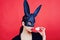 Easter woman. Woman rabbit, easter bunny girl. Red lip imprint on easter egg on red background. Female mouth kiss. Print