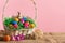 An Easter woven basket with Easter eggs stands on a linen cloth.