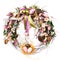 Easter wreath on a white background. Decoration of tulips, small pink and white flowers, greens and natural components. Nest with