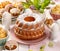 Easter yeast cake sprinkled with powdered sugar on the holiday table.