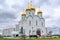 Eastern orthodox crosses on gold domes, cupolas, againts blue sky with clouds.