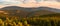 Eastern Sudetes, mountain landscape, view of the Snieznik Massif mountain peaks. The forests are lit by the setting sun