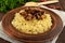 Eastern traditional wheat porridge - bulgur with roasted pieces fatty meats, bacon in a clay bowl