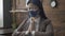 Eastern woman praying in silence while sitting at office desk. Beautiful woman in mask closed her eyes and clasped hands