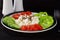 Easy breakfast with paprika, tomato, cucumber with cottage cheese and flax seeds on a plate on a dark background Healthy