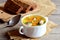 Easy fish soup recipe. Diet fish soup with potatoes, carrots and green onions in a bowl. Rye bread pieces, spoon