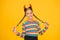 Easy holiday hairdo for long length hair. Halloween child hold long plait hairdo. Small girl wear red devil horns