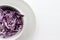 Easy homecooked creamy coleslaw from red cabbage in a bowl on white table background. Top view, copy space. Fresh vegetable salad