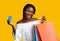 Easy Payments. Smiling Black Young Woman Holding Credit Card And Shopping Bags