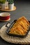 Easy recipe, snacks, minced pork meat filled fried wontons sort in black dish on weaving  placemat, grey placemat, brown wood