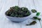 Easy three ingredient baked green kale chips with sea salt and olive oil, in gray bowl, horizontal