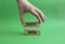 Easy win symbol. Wooden blocks with words Easy win. Beautiful green background. Businessman hand. Business and Easy win