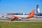 EasyJet aircraft on the Vienna International Airport VIE runway, with control tower in the back and clear blue skies