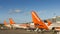 Easyjet airplanes and airport personnel at London`s Gatwick airport - South Terminal