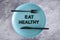 Eat healthy text on dining plate with fork and knife, dieting vs healthy nutrition and intuitive eating