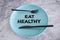 Eat healthy text on dining plate with fork and knife, dieting vs healthy nutrition and intuitive eating
