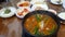 Eating boiling blood suasage red soup with pig\'s ear local Korean food soondae hot stew slowmotion