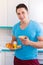 Eating breakfast young man in the kitchen portrait format smiling morning