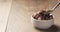 Eating chocolate icecream with hazelnuts on wood table