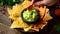 Eating corn chips nachos with guacamole