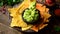 Eating corn chips nachos with guacamole