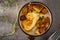 Eating egg with fries and fried salami from a rustic pan with herbs