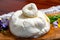 Eating of fresh handmade soft Italian cheese from Puglia, white balls of burrata foglia saporosa or burratina cheese made from