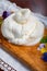 Eating of fresh handmade soft Italian cheese from Puglia, white balls of burrata foglia saporosa or burratina cheese made from