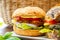 Eating of fresh and healthy vegetarian hamburgers with grilled spinach or pumpkin burgers, organic buns and vegetables