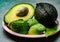 Eating of fresh ripe green organic hass avocado