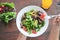 Eating healthy breakfast concept. Top view of woman holding dish of salad with variety vegetables.