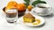 Eating lemon orange sponge cake in white ceramic dish and drinking black coffee in white ceramic cup.
