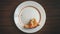 Eating of piece of pie on white plate on brown wood table top view stop motion seamless