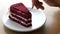 eating red velvet cake on plate