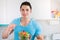 Eating salad young man in the kitchen healthy eat vegan copyspace