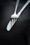 Eating utensils/fork and knife on black background