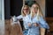 Eautiful blonde with glasses and her elderly mother are sitting in a cafe and drinking coffee. Mothers Day. Beautiful