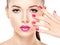 Eautiful woman face with pink makeup of eyes and nails.