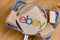 Ebay logo on a box under a magnifying glass. Boxes in the shopping cart